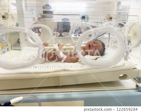 newborn baby in an incubator at hospital newborn baby in an incubator at hospital 122659284