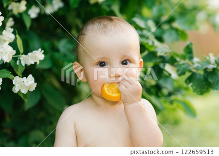 Baby Sitting In Water With Citrus And Jasmine Outdoors 122659513