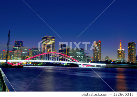 Sumida River Terrace - Night view of Tsukiji Bridge and skyscraper apartment buildings 122660315