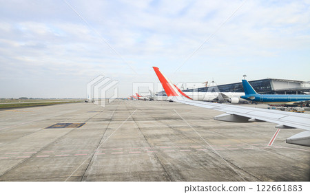 view from airplane window, panorama view of busy international airport. 122661883