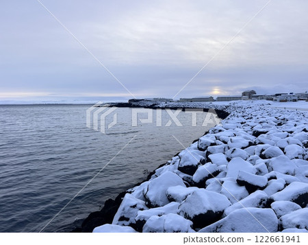 Beautiful view of Keflavik in winter with mountains and water on a background 122661941