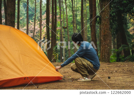 solo traveler in nature concept with asian man camping and see pink cherry blossom tree and pine tree with sunrise in springtime season solo traveler in nature concept with asian man camping and see pink cherry blossom tree and pine tree with sunrise in springtime season 122662000