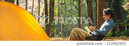 solo traveler in nature concept with asian man camping and work online with pink cherry blossom and pine tree in springtime season solo traveler in nature concept with asian man camping and work online with pink cherry blossom and pine tree in springtime season 122662003