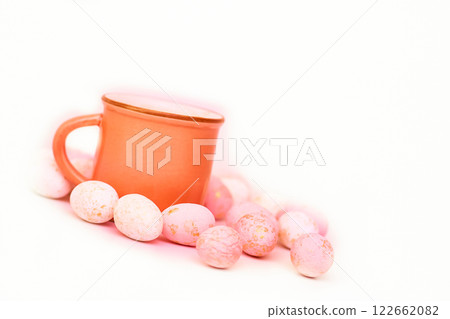 Tea time,coffee break. Orange cup with pink eggs Tea time,coffee break. Orange cup with pink eggs 122662082