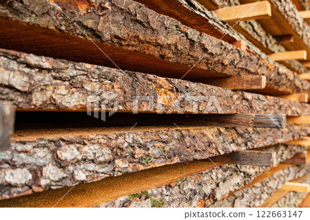 Planks on the sawmill as textures and background. Tree bark close up Planks on the sawmill as textures and background. Tree bark close up 122663147