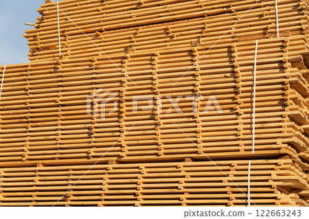 A stack of boards on a sawmill. Drying wood on a sawmill. Production of boards 122663243