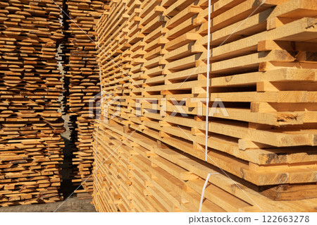 Stacked pine boards on a sawmill. Production of boards 122663278