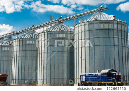 Metal tanks for storage of grain. Modern granary elevator. Loading and transportation of agricultural products by railway. 122663330