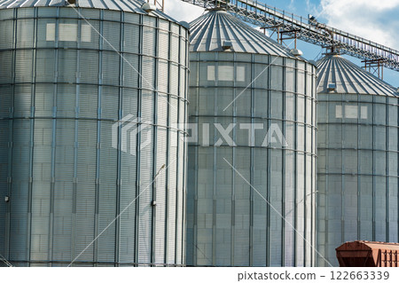 Granary elevator. Modern steel agricultural grain granary silos. Agro industry Granary elevator. Modern steel agricultural grain granary silos. Agro industry 122663339