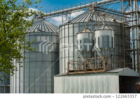 Agricultural Silos in Ukraine. Modern steel agricultural grain granary silos. Export of grain crops by railway. 122663357