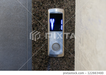 A sleek elevator panel with illuminated floor buttons fits perfectly with the apartment's modern design 122663480