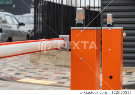 Security barrier is closed, preventing entry into the parking lot, ensuring control and safety at the entrance to the facility Security barrier is closed, preventing entry into the parking lot, ensuring control and safety at the entrance to the facility 122663585
