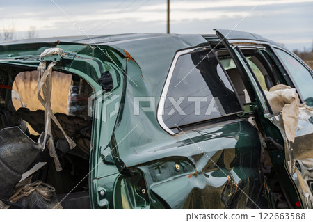 A damaged car sits at an accident site, showcasing the destructive impact of crashes on transportation safety and the importance of insurance 122663588