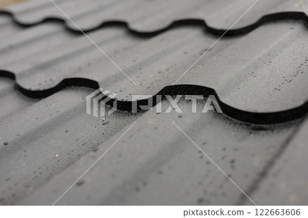 Close-up view of a metallic tile rooftop displaying an innovative design perfect for modern residential buildings, enhancing durability 122663606