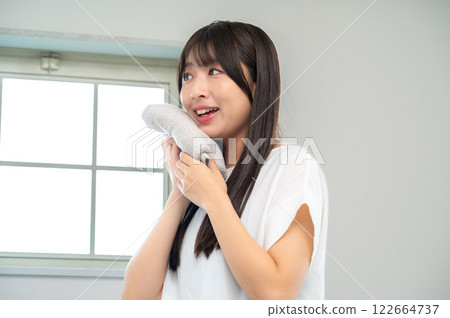 Japanese woman wiping her face with a towel Japanese woman wiping her face with a towel 122664737