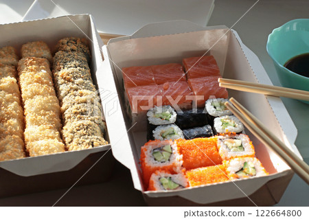 fish bun and sushi set breaded rice japanese cuisine japanese food delivery bright buns hand chopsticks with roll california philadelphia white dishes soy saucehands holding chopsticks fish bun and sushi set breaded rice japanese cuisine japanese food delivery bright buns hand chopsticks with roll california philadelphia white dishes soy saucehands holding chopsticks 122664800