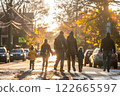 Adults walking children to school on a sunny day 122665597