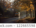 A school bus stopping on a quiet suburban street surrounded by autumn trees with golden leaves, soft morning sunlight, and a peaceful neighborhood atmosphere 122665598