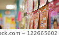 Blurred close-up of colorful information packets and flyers displayed on a wall in a bright hallway, creating a vibrant and organized atmosphere 122665602