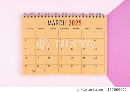 March 2025 desk calendar made from brown paper page on purple background. 122666021