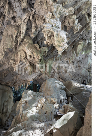 View of Stalactites and Stalagmites and natural light interior of the old limestone cave. View of Stalactites and Stalagmites and natural light interior of the old limestone cave. 122666383