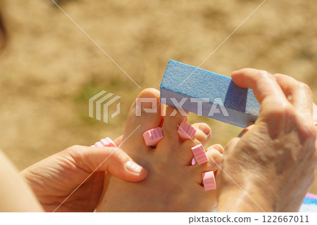 Woman pedicure outdoor 122667011