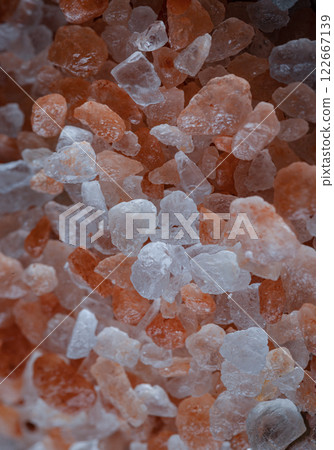 Close-up view of Pink Himalayan Salt on Bright colors textured surface. 122667139