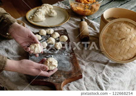 Making Asian steamed dumplings Making Asian steamed dumplings 122668254
