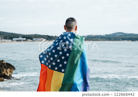 man wrapped in a rainbow american flag man wrapped in a rainbow american flag 122668442