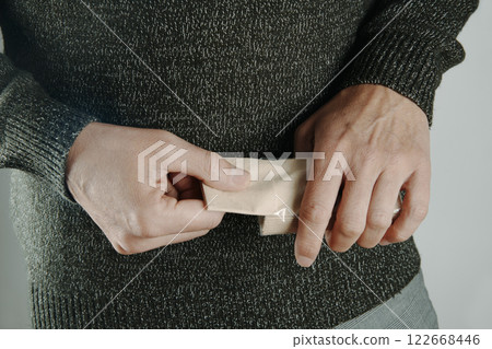 man taking a tissue out of a tissue pack 122668446