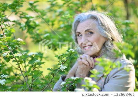 Portrait of a beautiful elderly woman in the park 122668465