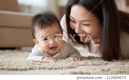Happy Asian young mother playing with her cute baby on the floor at home Happy Asian young mother playing with her cute baby on the floor at home 122669674