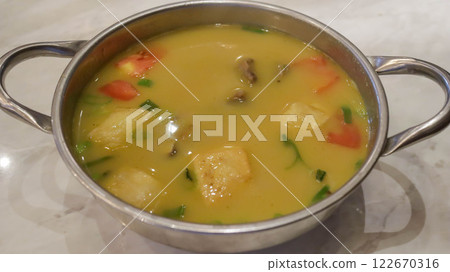 Beef soto features a savory blend of broth, meat, and vegetables. Often, it includes aromatic spices like lemongrass, turmeric, and shallots, creating a rich and flavorful Indonesian delight. 122670316