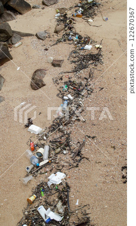 The beach is filled with rubbish carried from sea water. The beach is filled with rubbish carried from sea water. 122670367