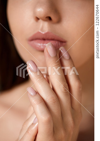 Manicure and Hands Spa. Beautiful model girl with a manicure nails. Woman natural makeup and care for hands cosmetics. Facial treatment . Cosmetology, beauty. Skin care 122670644