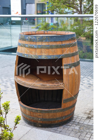 An empty wooden barrel on a city street, part of the city's decor and architecture 122670699