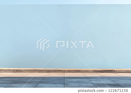 Bright blue wall and sidewalk create a tranquil urban setting on a sunny day 122671238