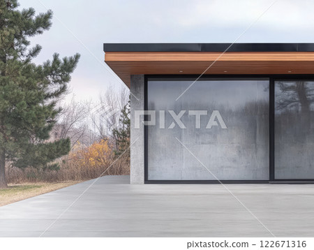 Modern architectural design features a sleek glass facade and minimalist style in a natural setting 122671316