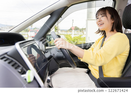 Young woman driving 122671424