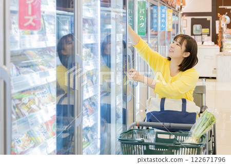 A disabled woman shopping at a supermarket has trouble with the height of the displays (property release obtained) A disabled woman shopping at a supermarket has trouble with the height of the displays (property release obtained) 122671796