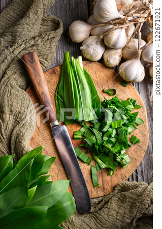 Cutting fresh organic bear's wild garlic leaves Cutting fresh organic bear's wild garlic leaves 122671921