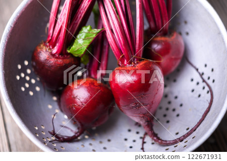 Fresh ripe beets on a metal colander close up Fresh ripe beets on a metal colander close up 122671931