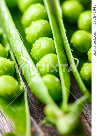 Green sugar snap peas with water drops close up Green sugar snap peas with water drops close up 122671945