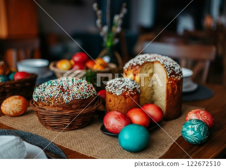 Colorful Easter Eggs and Baked Goods Displayed on a Rustic Wooden Table During a Festive Spring Celebration Gathering Colorful Easter Eggs and Baked Goods Displayed on a Rustic Wooden Table During a Festive Spring Celebration Gathering 122672510