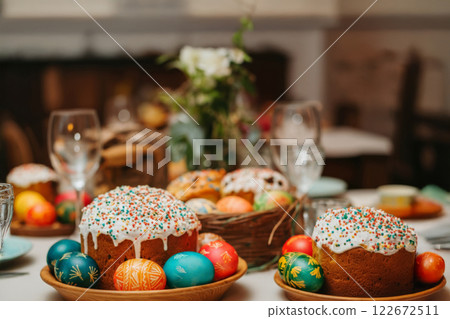 Colorful Easter Eggs and Festive Pastries Decorate a Springtime Gathering Table Colorful Easter Eggs and Festive Pastries Decorate a Springtime Gathering Table 122672511