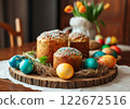 Easter Celebration Features Colorful Eggs and Traditional Sweet Breads on a Wooden Platter With a Rustic Touch 122672516