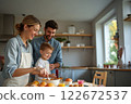 Family Enjoys a Joyful Easter Celebration With Colorful Eggs and Festive Treats in a Cozy Kitchen 122672537