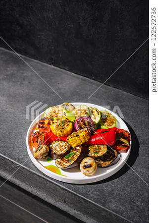 Grilled vegetables on a plate showcasing vibrant colors and textures in a modern kitchen setting 122672736