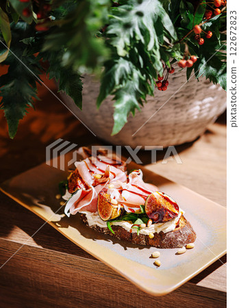 Delicious open-faced sandwich with fresh ingredients and vibrant presentation on a wooden table Delicious open-faced sandwich with fresh ingredients and vibrant presentation on a wooden table 122672823