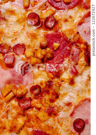 Delicious pizza topped with savory ingredients including meats and vegetables on a golden crust Delicious pizza topped with savory ingredients including meats and vegetables on a golden crust 122672927